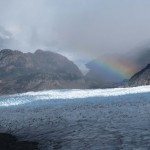 A rainbow over grey glacier. (Photo by Tye Chapman)