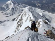 Climbing on the West Buttress with Mt Foraker behind (Eric Simonson)
