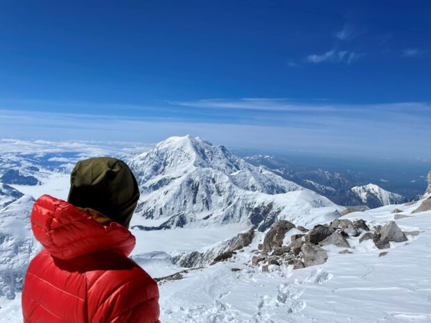 A climber at the 'Edge of the World' just outside 14K Camp overlooking the Kahiltna Glacier and Mt. Foraker (Sultana). (Audrey Simonson)