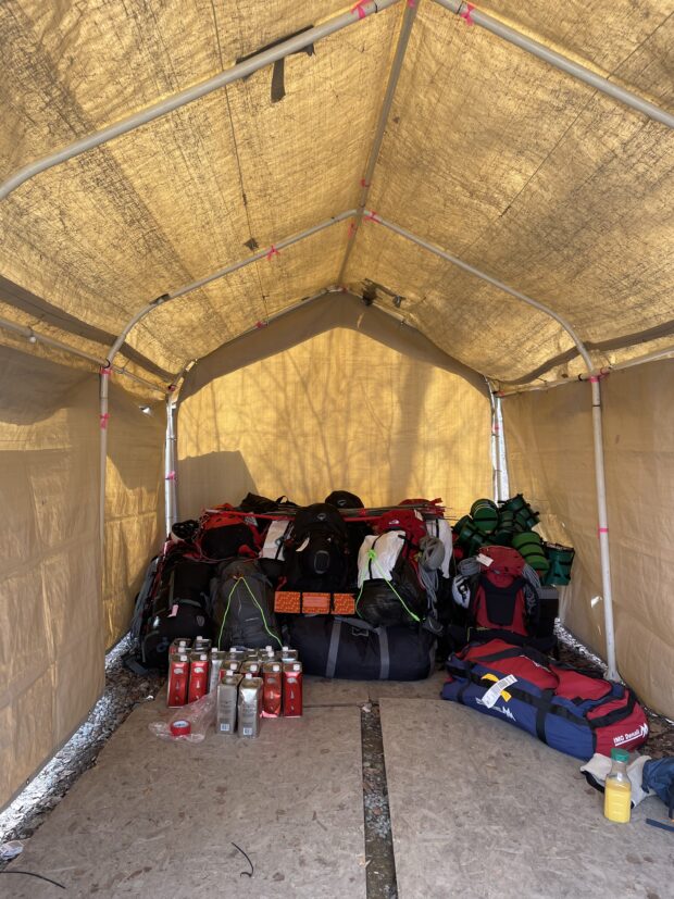 A big pile of gear in a tent, waiting to head onto the mountain.