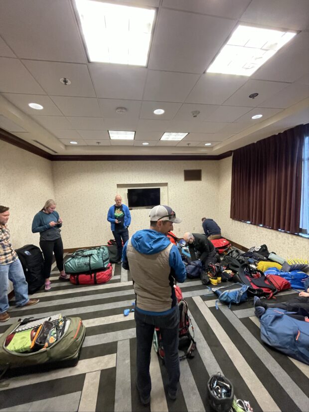 Team 1 conducts their gear check, led by Lead Guide Forrest Baldwin.
