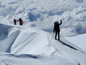An IMG D Team arrives on the summit