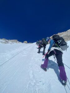 A woman smiles from the fixed lines about 14k Camp on Denali/McKinley.