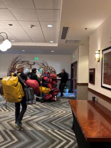 Team 5 dragging their gear through the lobby of the Anchorage Embassy Suits Hotel. 