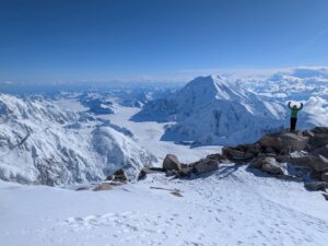 IMGD guide Grace Coady stands on the West Buttress looking out at Mount Foraker