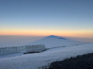 Looking west at sunrise with Kilis shadow and Meru Peak (Phunuru Sherpa)