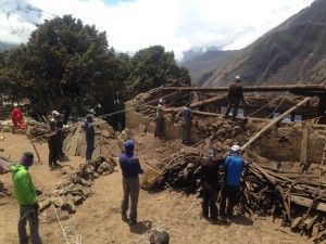 IMG climbers helping to bring down the main beam on Palden Sherpa's house damaged in the earthquake. (Photo Max Bunce)