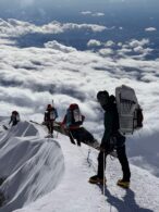 A team walks along a ridge up to the Summit of Denali